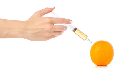 Syringe in the hands of orange on a white background isolation