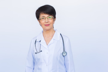 Portrait of doctor woman with stethoscope over white background
