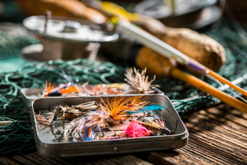Closeup of handmade angler equipment with rods and fishing flies