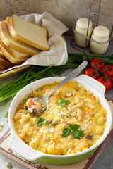 Homemade Baked Casserole crumble with red fish, white bread and cheese on stone or slate background. Proper nutrition. Healthy lifestyle.