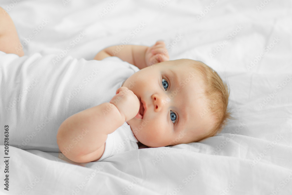 Wall mural portrait baby on the bed