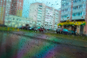 City is through the glass in the rain drops