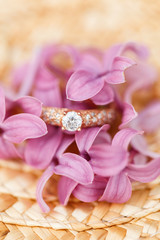 jewelry engagement ring with diamonds and spring lilac flowers