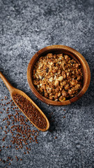 Healthy sweets cooking ingredients: granola, sesame and flax seeds, cocoa in separate bowls on gray background. Flatlay with copy space