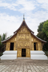 Fototapeta premium Front view of the ornate Funeral chapel at the Wat Xieng Thong temple (