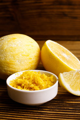 Lemon and juice on a wooden background