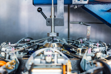 The mechanism of a braiding machine close-up.