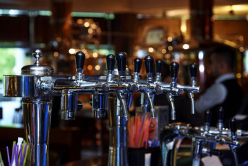 Fototapeta na wymiar Beer tap on the bar in the restaurant.