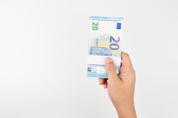 Stack of twenty euro bills isolated on white background.