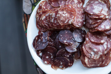 Food tray with delicious salami Meat platter with selection - Cutting sausage and cured meat on a celebratory table.