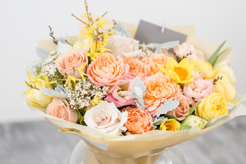 beautiful bouquet of flowers set on wooden table. the work of the florist at a flower shop. A small family business. Horizontal photo