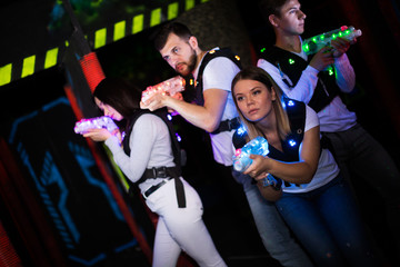 Young people playing laser tag