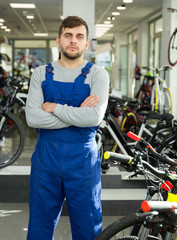 Fototapeta na wymiar repairman standing in bicycle shop