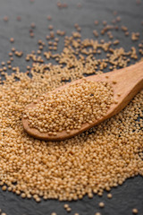 fresh amaranth grains on a rustic background