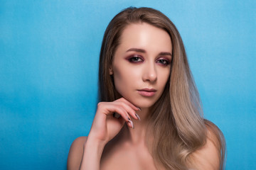 Beautiful young girl on a blue background.