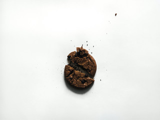 American cookie Top view One broken cookie with chocolate chips is lying on white background Photo template with copy space