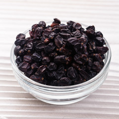 dried barberry berries on the rustic background