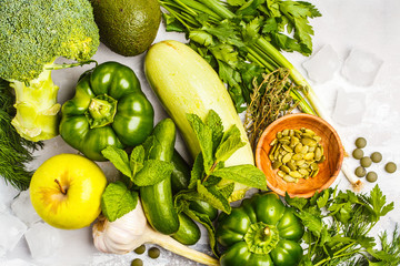 Green vegetables on a white background. Vegetable vegan diet food background, top view. Healthy lifestyle concept.