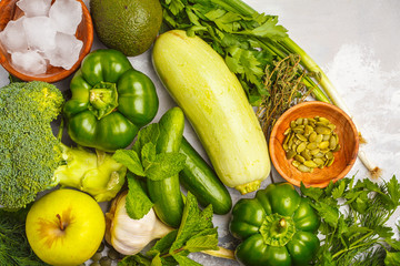 Green vegetables on a white background. Vegetable vegan diet food background, top view. Healthy lifestyle concept.
