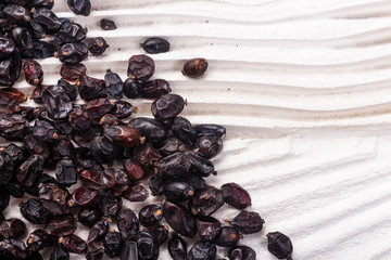 dried barberry berries on the rustic background