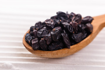 dried barberry berries on the rustic background