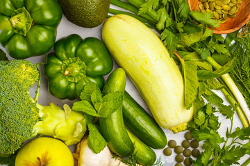 Green vegetables on a white background. Vegetable vegan diet food background, top view. Healthy lifestyle concept.