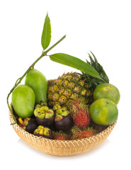 rambutan. pineapple. manggo green. orange green. mangosteen. in basket wood. isolated on white background