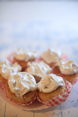 Cupcakes with white cream on a wooden background