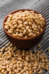 peeled pine nuts on a rustic background