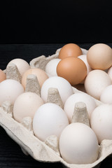 Fresh eggs in egg rack put on wood table prepare for cooking in top view flat lay with copy space on wood table in still life concept for background or wallpaper. High protein food and delicious taste