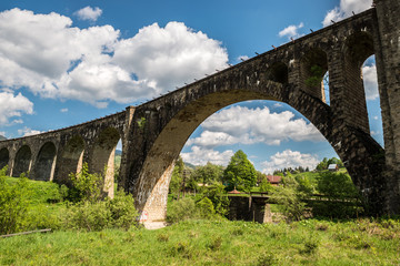 Fototapeta premium Old railway bridge, old viaduct Vorohta, Ukraine. Carpathian Mountains, wild mountain landscape.