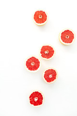 Sliced grapefruits on white background. Flat lay, top view.