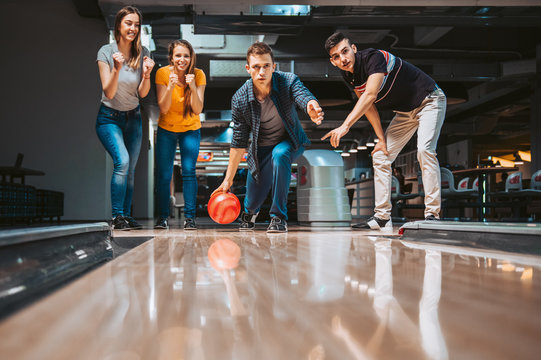 Friends having fun while bowling, happy hour