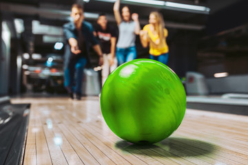 Friends having fun while bowling, selective focus