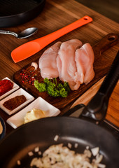 raw chicken fillets on wooden cutting board, top view. cooks in the kitchen. Concept: Cooking, Prescription, Healthy Eating