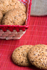 Savory cookies sprinkled with sesame seeds, sunflower on table and burlap background