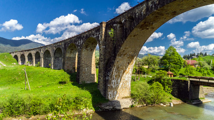 Old railway bridge, old viaduct Vorohta, Ukraine. Carpathian Mountains, wild mountain landscape.