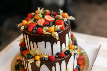 Wedding or birthday cake with berries. Sweet pie on banquet in restaurant.