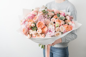 bouquet of beautiful flowers in women's hands. Floristry concept. Spring colors. the work of the florist at a flower shop.