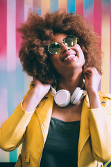 Mixed race woman in a colorful background wall
