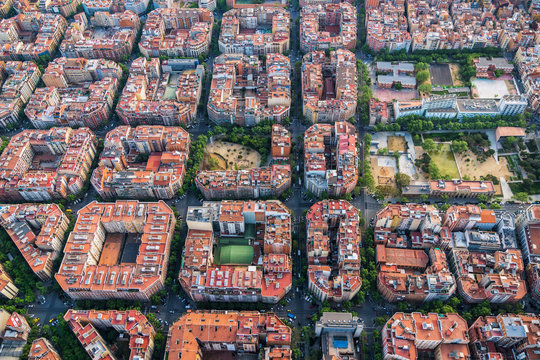 Aerial helicopter view of Barcelona architecture, high angle view of the city typical urban grid, Spain