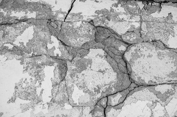 Original background of natural cement plaster on the wall of gray plain with the texture of cracks and bricks .