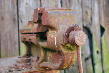 old clamp vice on a wooden background