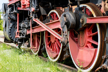 Fototapeta na wymiar Chassis of the old train. Steel heavy wheels of a steam locomotive.