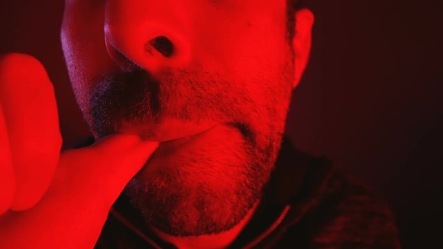 Close up of man sucking his thumb