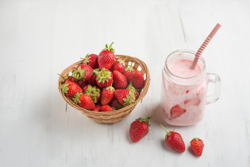 Strawberry-milkshake with strawberries on a light background