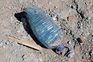 Garbage left in the forest. Littered with various plastic impurities.