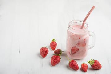 Strawberry yogurt with strawberries on a light background with empty space for writing