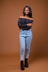 Young beautiful African Zulu woman against brown background