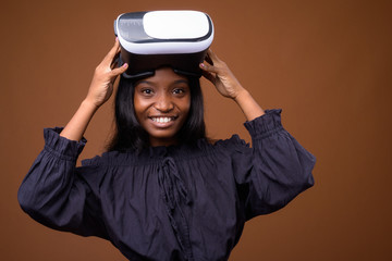 Young beautiful African Zulu woman against brown background